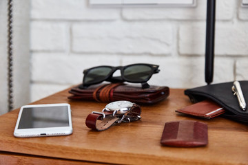Male daily items over bedside table.