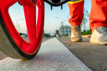 Close up measuring road distances with a measuring wheel