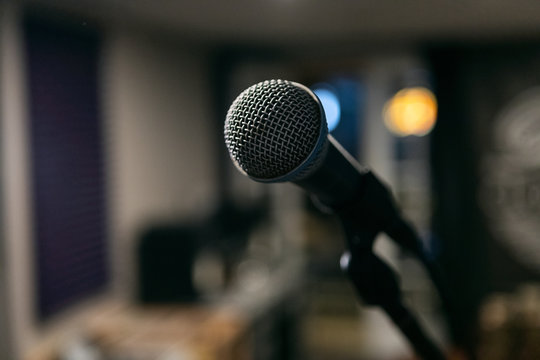Musician: Microphone With Man Looking At Records In Background