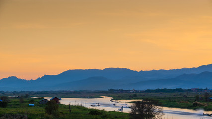 A folk village in beautiful landscape nearly lake with mountains background. Inle lake,Myanmar.
