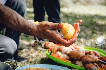 A man makes a potato kebab