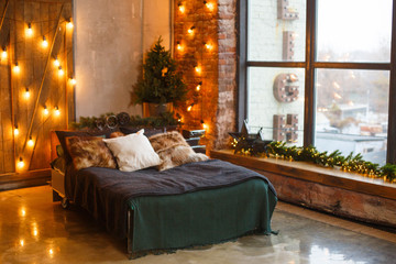 Stylish Christmas interior , bedroom with a lot of lights. Comfort home. Christmas decorated room...
