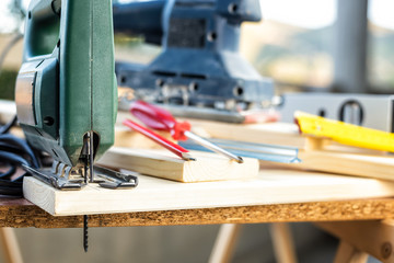 Professional woodworking tools, manual electric saw for cutting wood. Housework do it yourself. Stock photography.