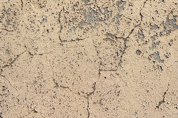 Texture of a concrete wall with cracks and scratches which can be used as a background
