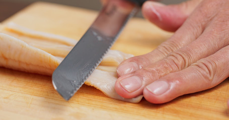 Cutting Fresh Geoduck on wooden board