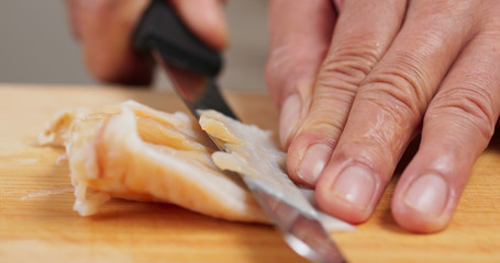 Cutting Fresh Geoduck on wooden board