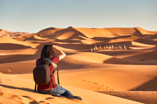 Young Woman Taking Photos In Desert