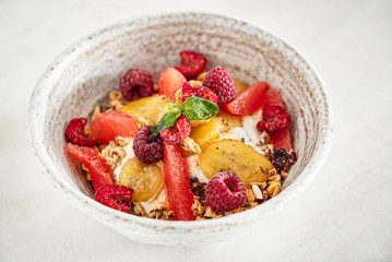 granola with banana and raspberries