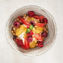 granola with banana and raspberries