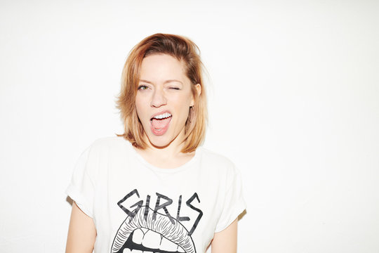 Rebel young woman blinking at camera