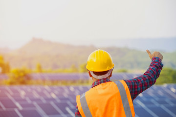 Happy working at solar power station, electrician is repairing, Engineer team with solar panel, concept of sustainable resources.