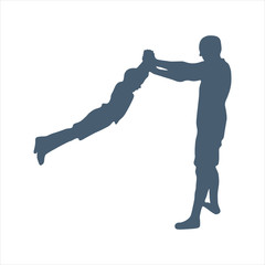 Silhouettes of father and child. Dad twirls his son in his arms. The boy was five years old.