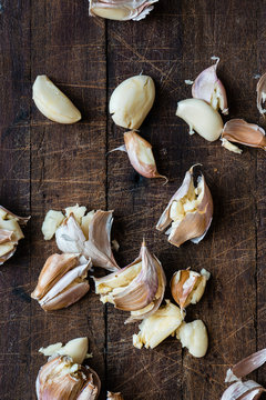 smashed garlic on a wooden board, with copyspace