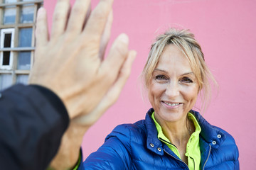 Happy senior woman High Five.