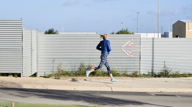 Faceless runner industrial zone.