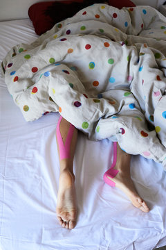 Kinesiotape legs bed recovery.