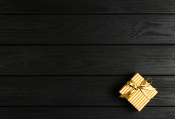 top view of a gift box on a black wooden background