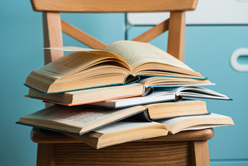 books on the wooden chair