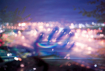 Ghostly hand surrounded by city lights
