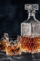 Glasses of the whiskey with a square decanter