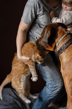 Woman with her daughter pampering her pets