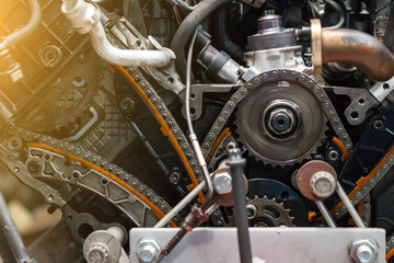 Close-up on a disassembled engine with a view of the gas distribution mechanism, chain, gears and...