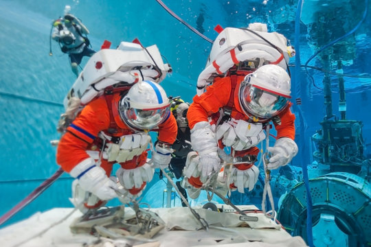 Cosmonaut training in the pool, in spacesuits. Elements of this image were furnished by NASA