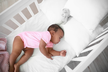 Obraz na płótnie Canvas Little African-American baby sleeping in bed