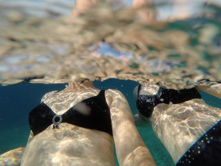 Two women swimming in clear blue Adriatic sea