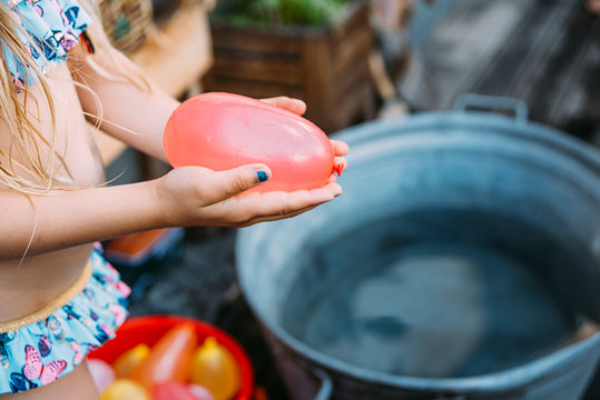 Girl with colorful water bombs
