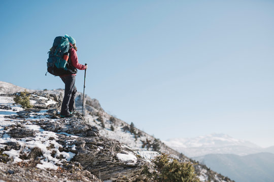 hiker with sticks thru the mountain