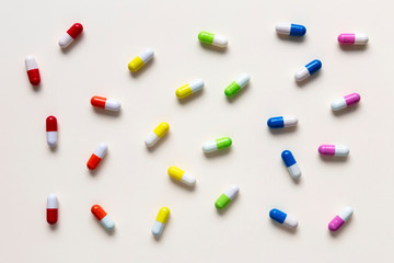 Colorful capsule pills in rainbow order