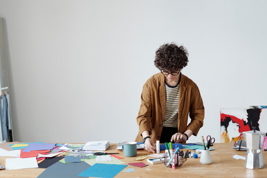 Curly woman making colorful collage