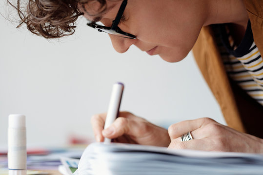 Woman drawing on colorful collage