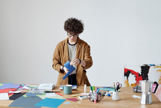 Young woman making abstract collage