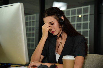 Woman in headphone work as operator of call centre feeling stress and worry about her frustrated problem working/suffering strain/high strung/headache