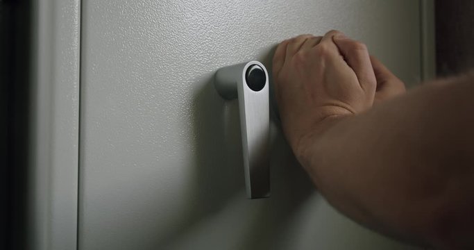 Somebody opening and closing his gun safe with combination lock.