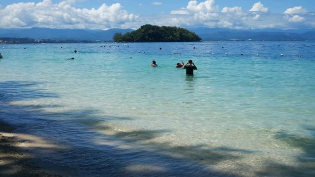 panning shot of tourist at manukan island