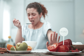 Curly woman having skin rash because of red vegetables