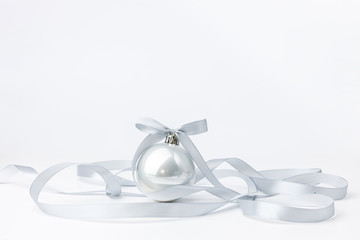 Christmas balls with silver ribbon on white background. Christmas decor and toys. 