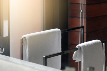 White clean towel hanging on towel rack in the bathroom