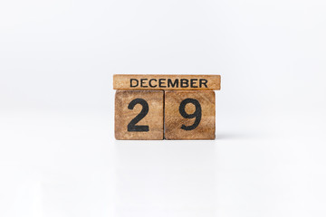 Business and design concept - geometric floating wooden cube on white background. Desember Calendar.