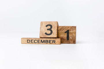 Business and design concept - geometric floating wooden cube on white background. 31st Desember. Happy New Year.