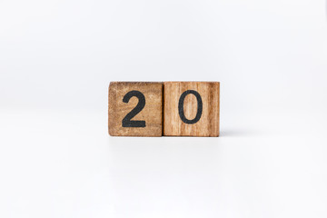 Business and design concept - geometric floating wooden cube on white background. 2020 year.