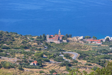Coastal town lying on the island of Vis on the Adriatic Sea, view on Church of Saint Nicholas, Komiza, Croatia