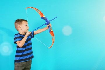 Boy shoots a bow at a target on the blue backgrounds