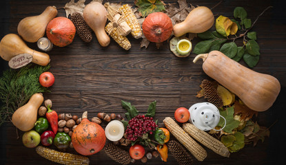 Thanksgiving Frame. Thanksgiving day concept. Autumn background from vegetables and fruits and fallen leaves with pumpkins and candles on old wooden table.