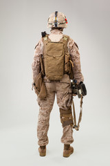 Studio shoot of modern infantry soldier, U.S. marine rifleman in combat uniform, helmet and body armor