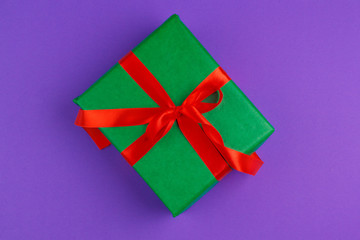 beautiful gift box wrapped in holiday paper with bow, top view