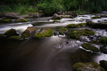 Water streaming in river in summer night